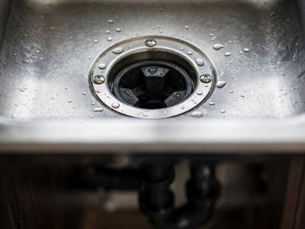 Close-up of a kitchen sink drain opening
